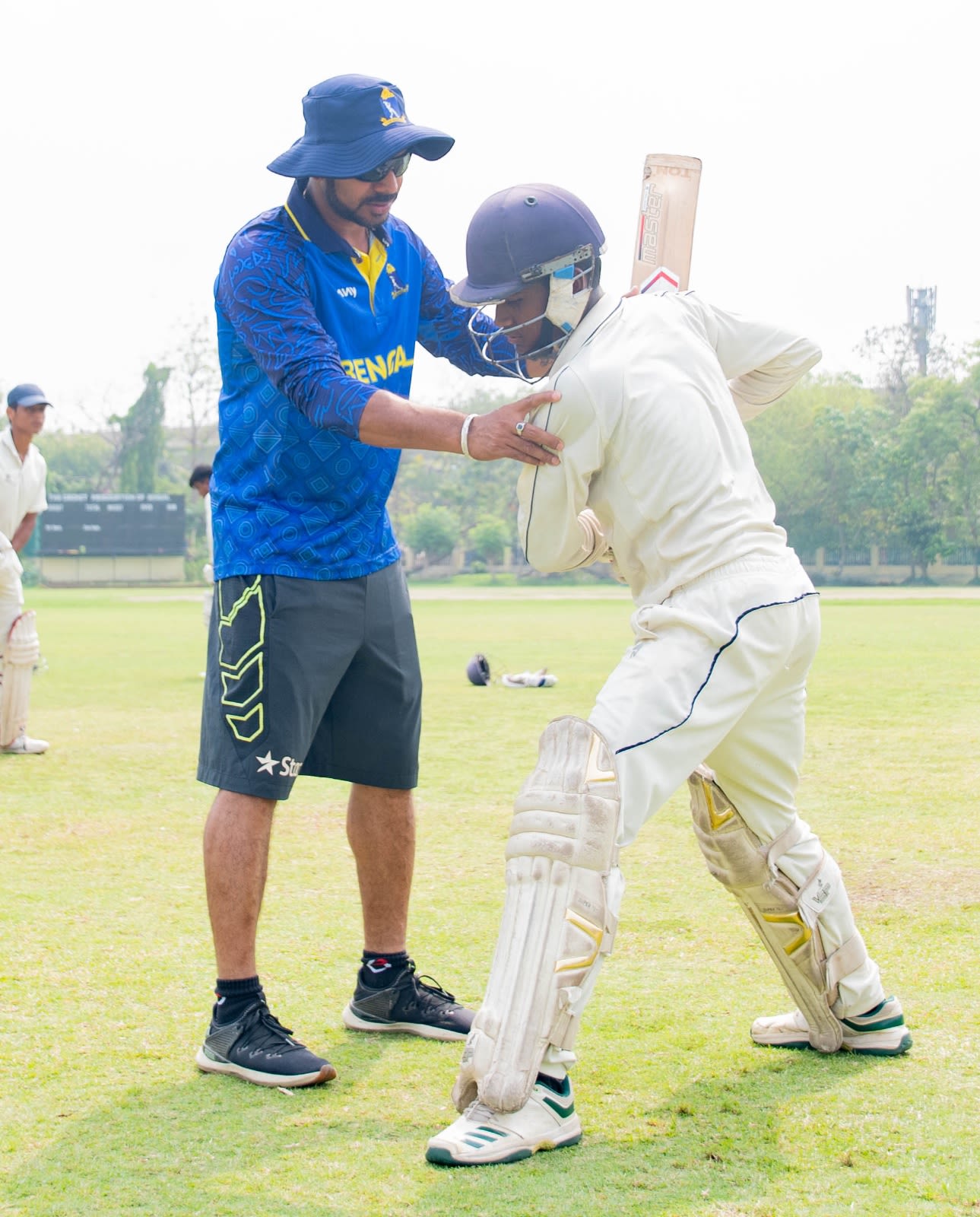 Manoj Tiwary helps an Under-16 Bengal batter at a camp