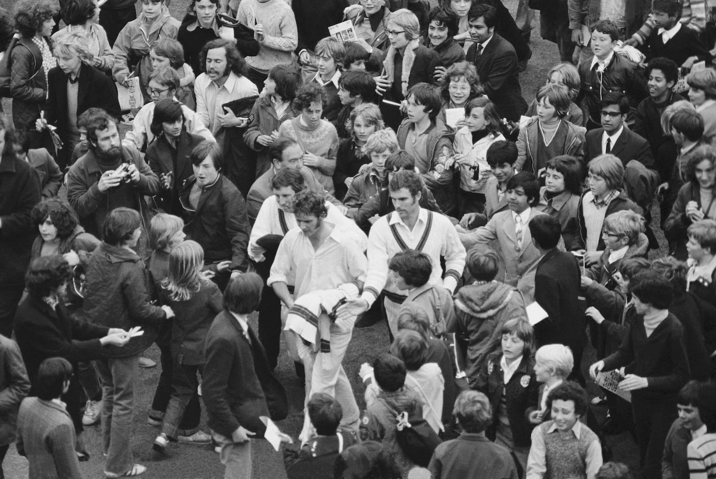 Bob Massie is mobbed after his record-breaking 16-wicket match haul