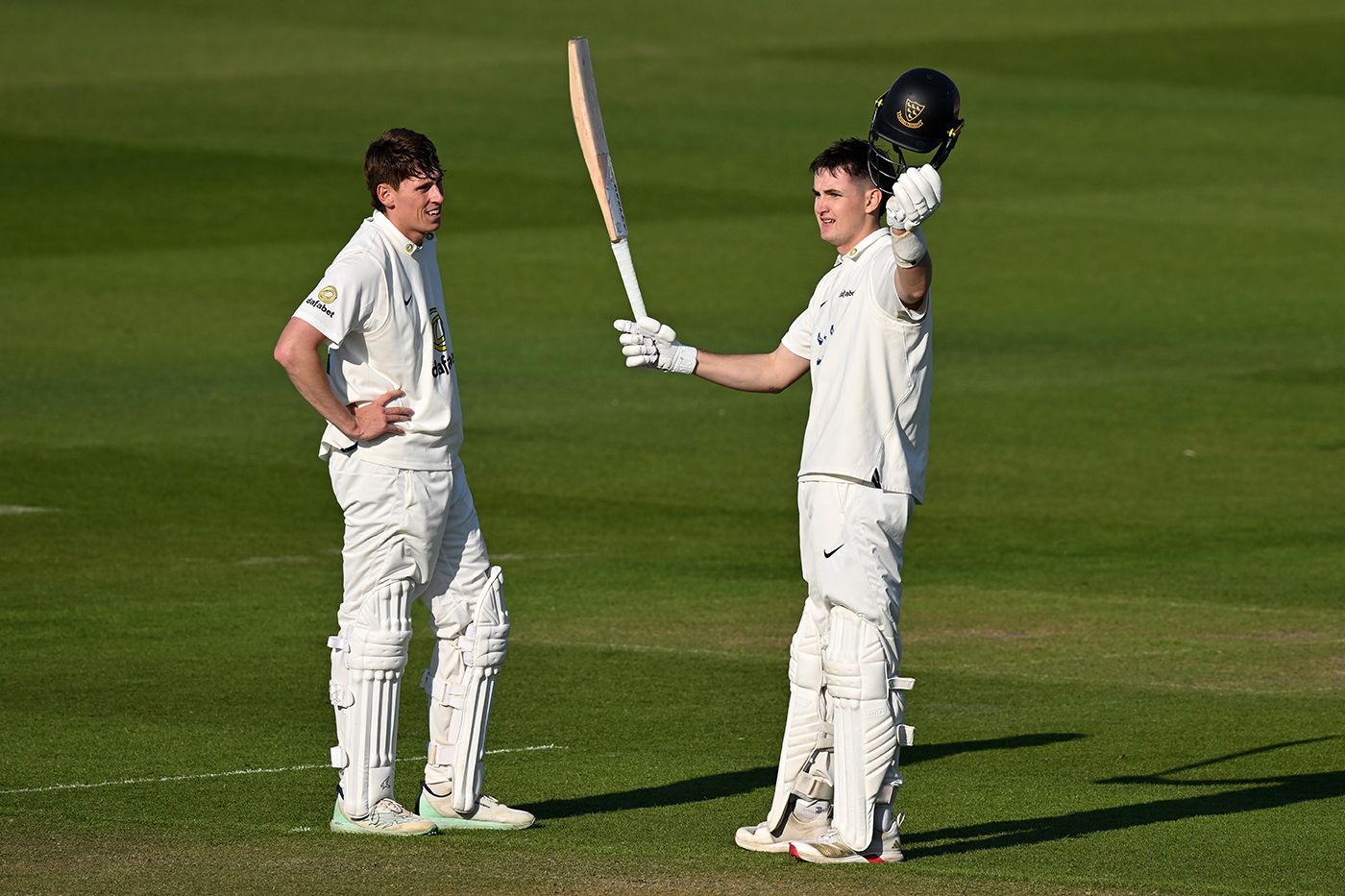 Jack Carson celebrates after reaching his century