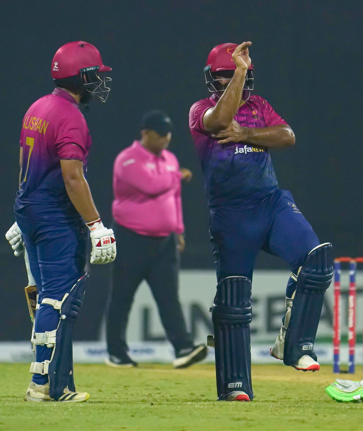 Asif Khan does the snake gesture as Alishan Sharafu looks on after hitting the winning runs