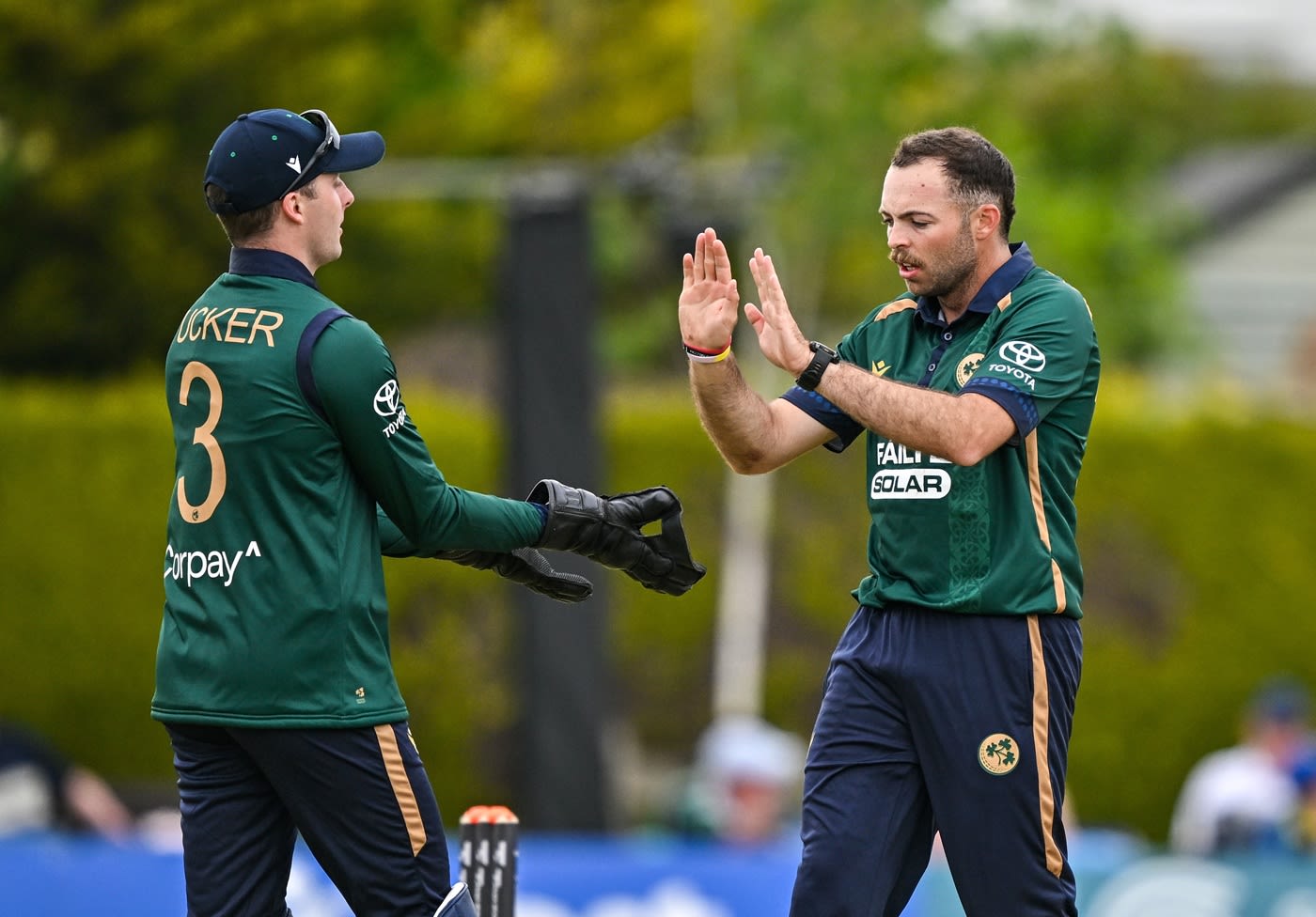 Lorcan Tucker and Liam McCarthy celebrate Keacy Carty's wicket