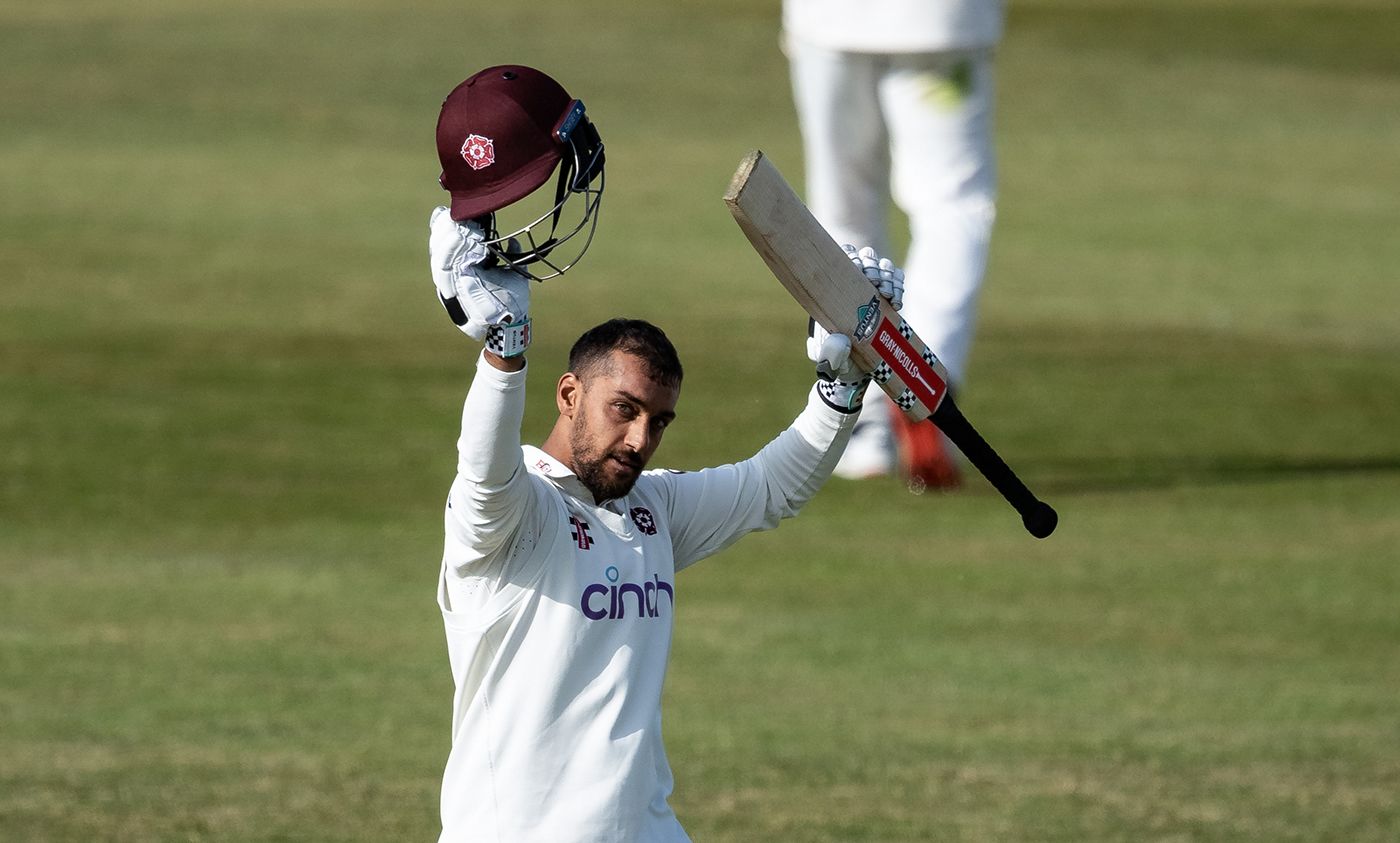 Saif Zaib raises his bat on reaching a century