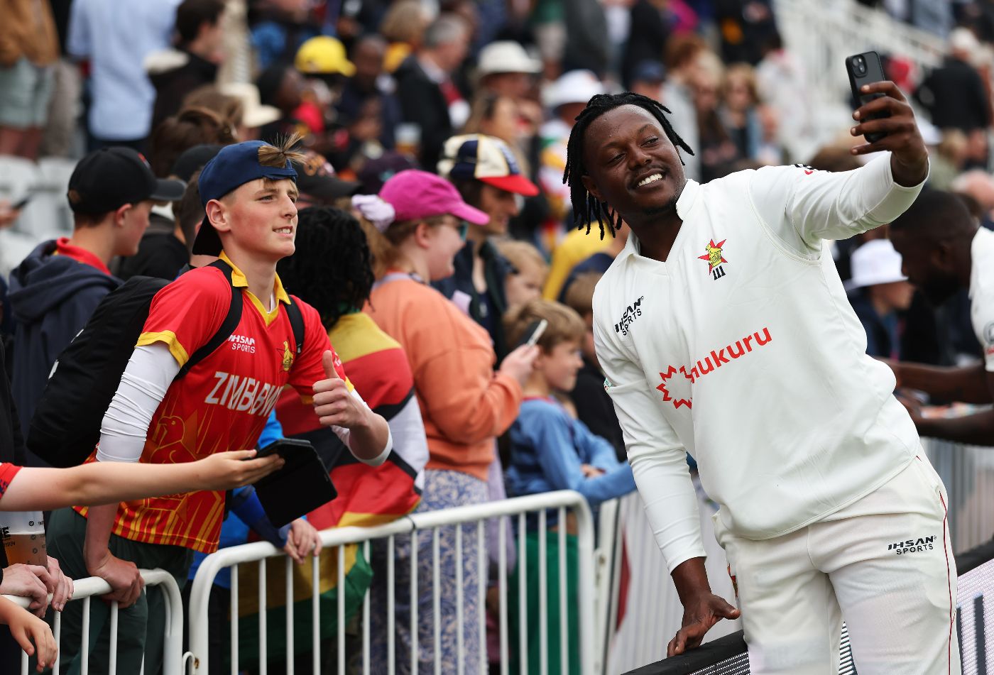 Victor Nyauchi poses for a selfie with a Zimbabwe fan