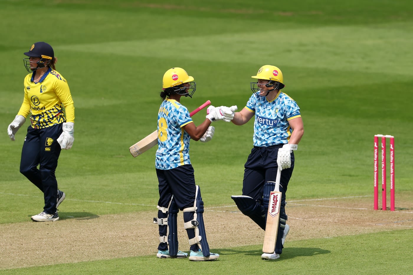 Harris (right) and Perrin celebrate the former's 50 from 16 balls