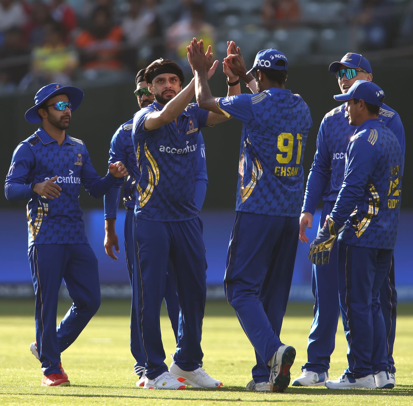 Naveen-ul-Haq celebrates a wicket with his teammates