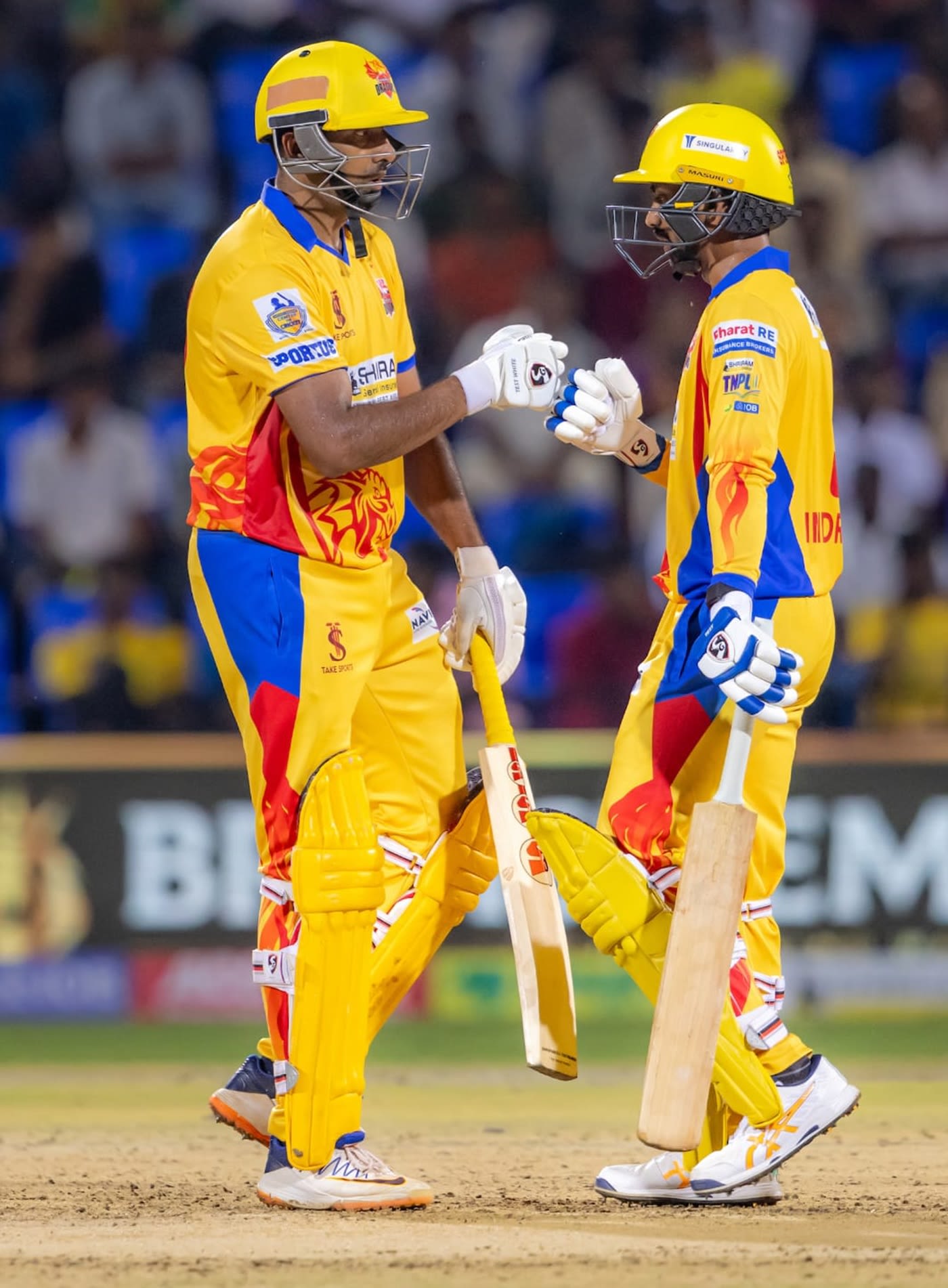 R Ashwin and B Indrajith punch gloves