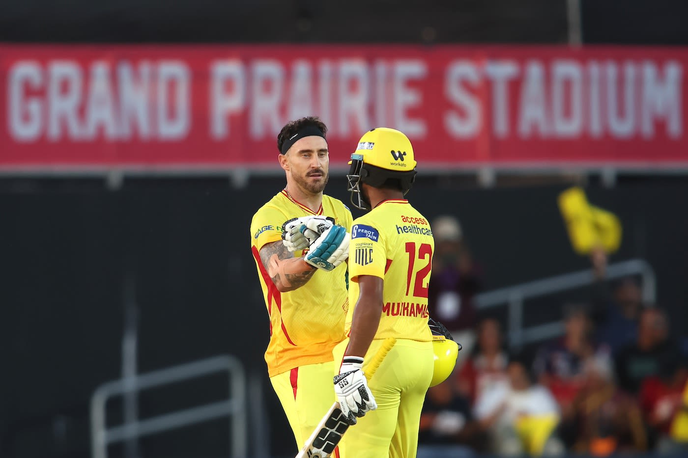 Faf du Plessis celebrates with Saiteja Mukkamalla after getting to his century