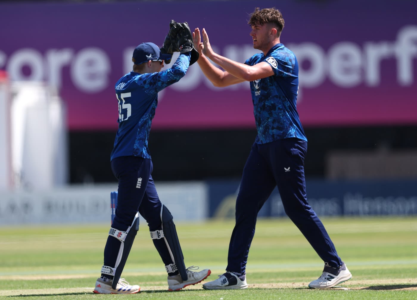 Alex Green celebrates one of his three wickets with wicketkeeper Thomas Rew