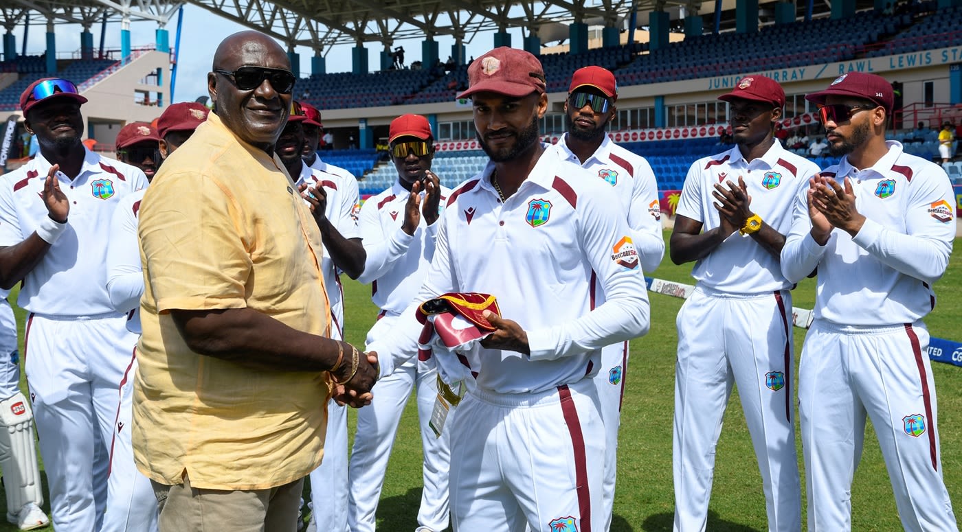 Kraigg Brathwaite receives a special cap for his 100th Test from Roddy Estwick