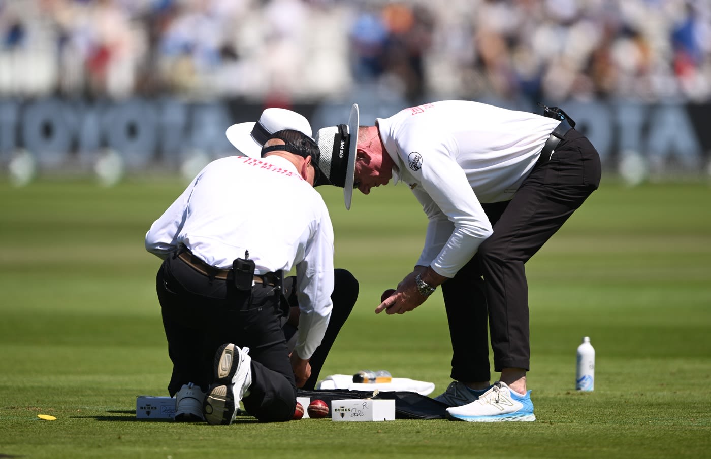 Umpire Paul Reiffel looks for a new ball