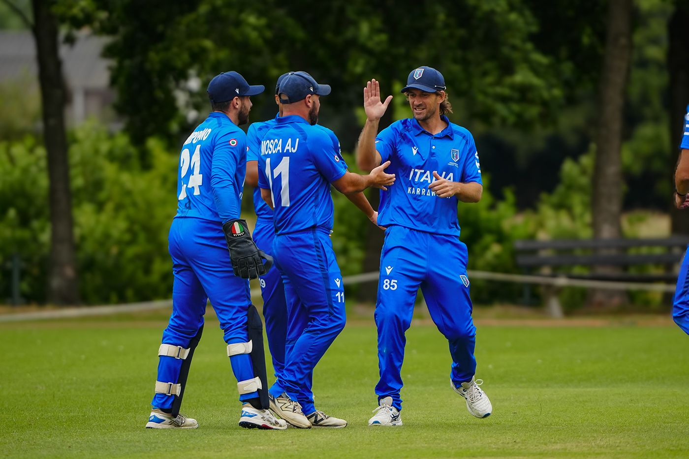 Joe Burns celebrates a wicket with his Italy team-mates