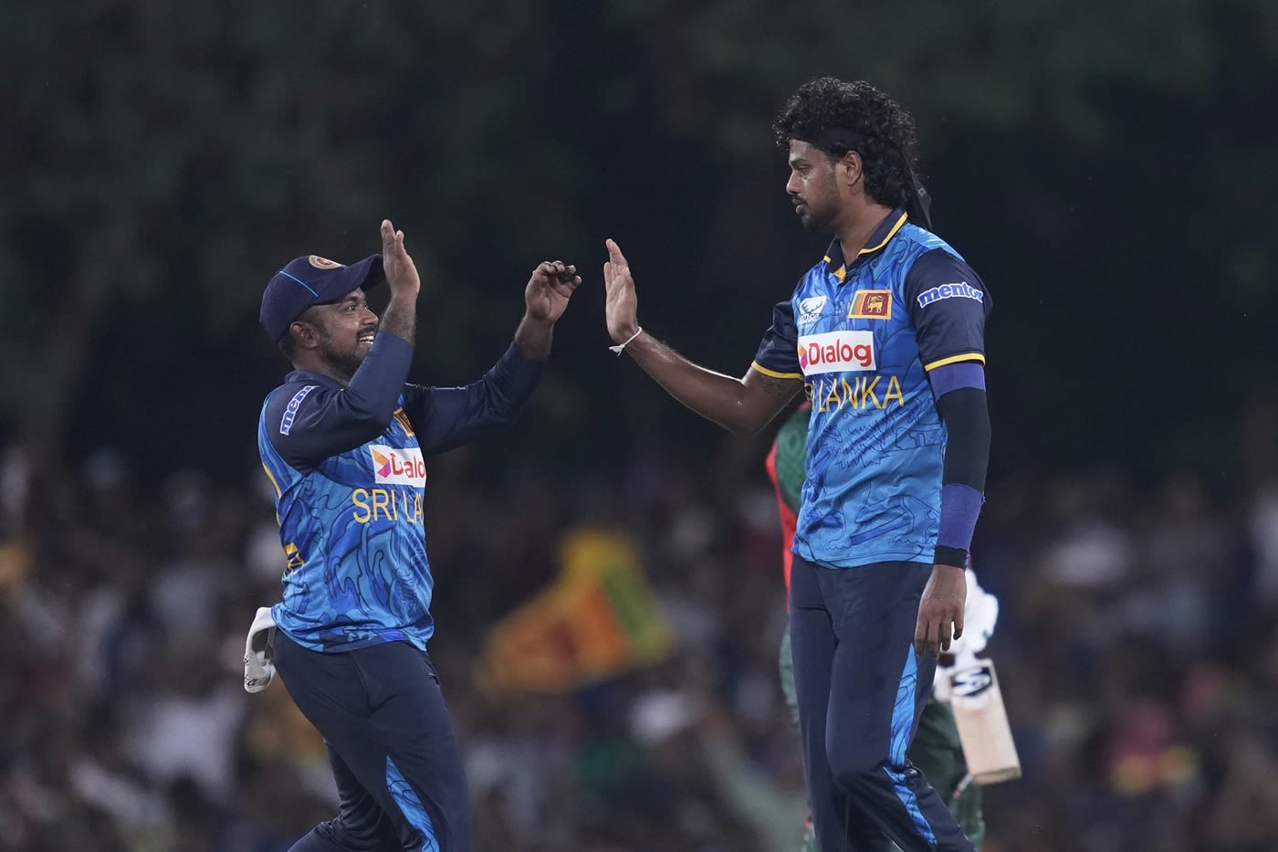 Binura Fernando celebrates a wicket with Charith Asalanka