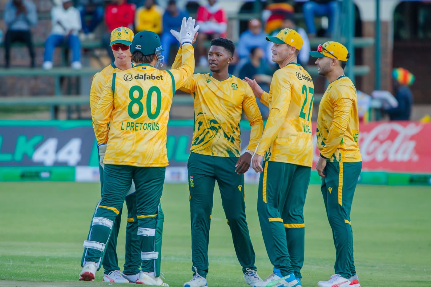 Nqabayomzi Peter celebrates with his team-mates after dismissing Clive Madande