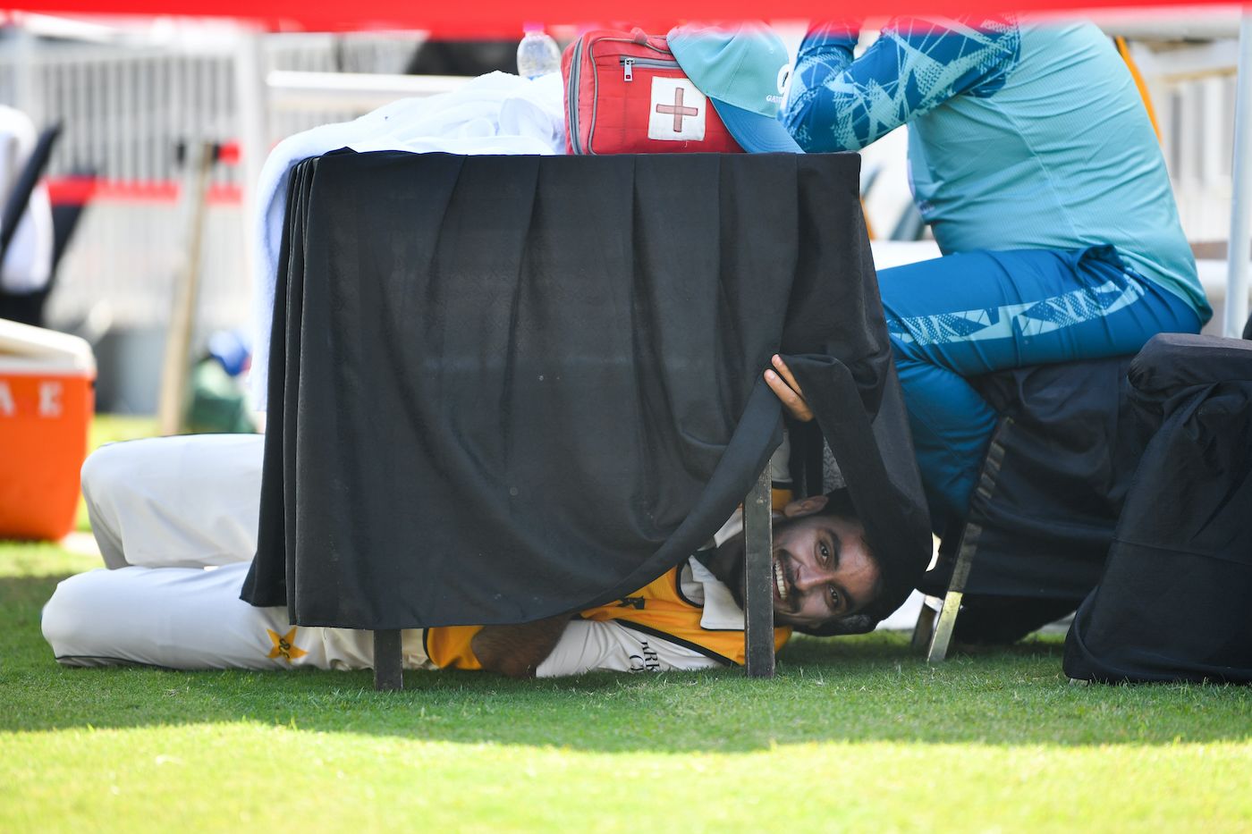 Mehran Mumtaz tries to find a bit of shade under a table