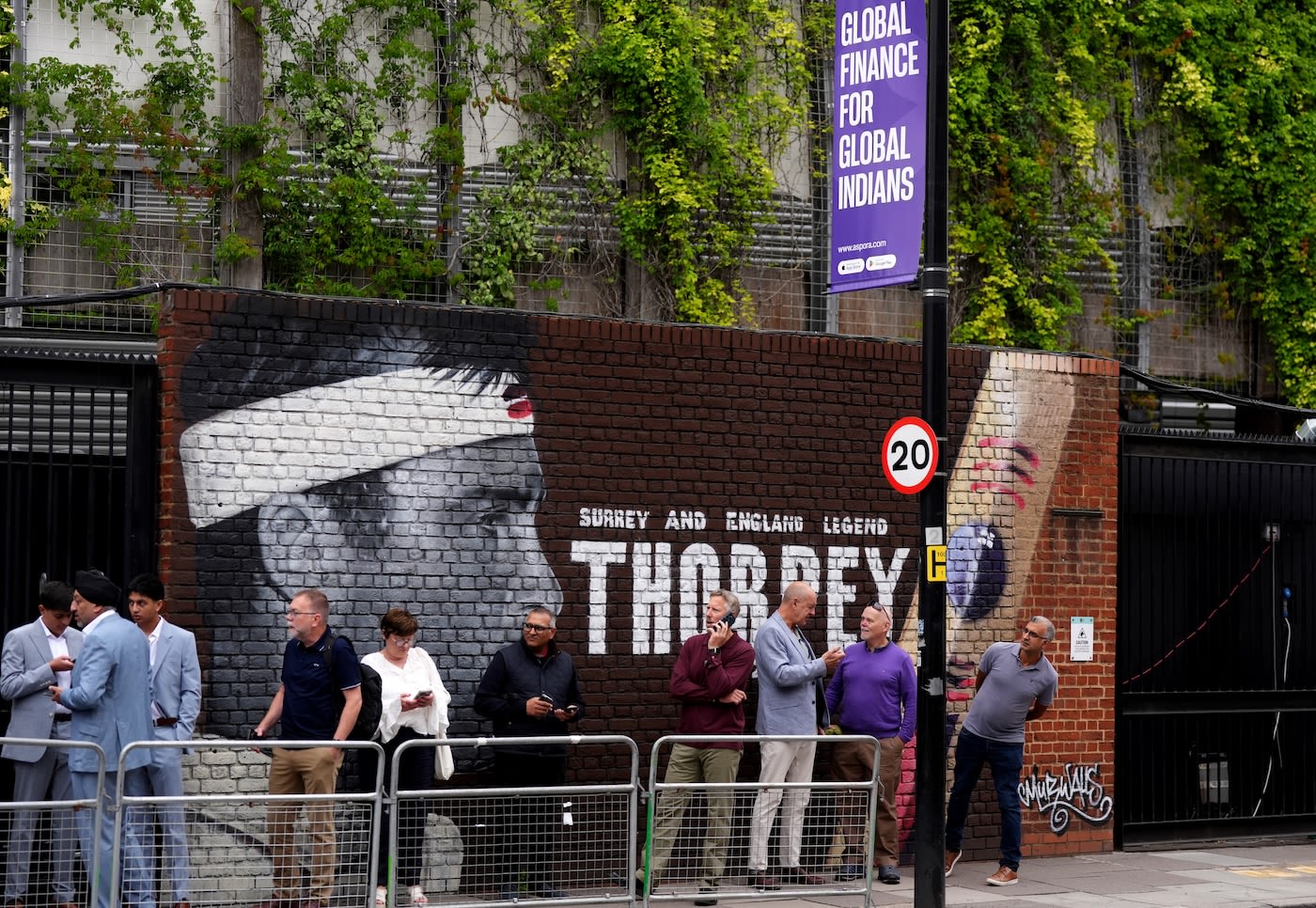 Fans queue up in front of the Graham Thorpe mural outside The Oval