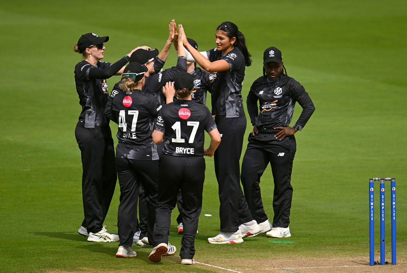 Mahika Gaur celebrates with team-mates after taking the wicket of Tammy Beaumont