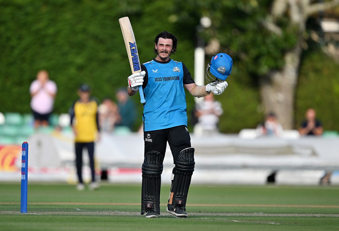 Rob Jones celebrates reaching his century