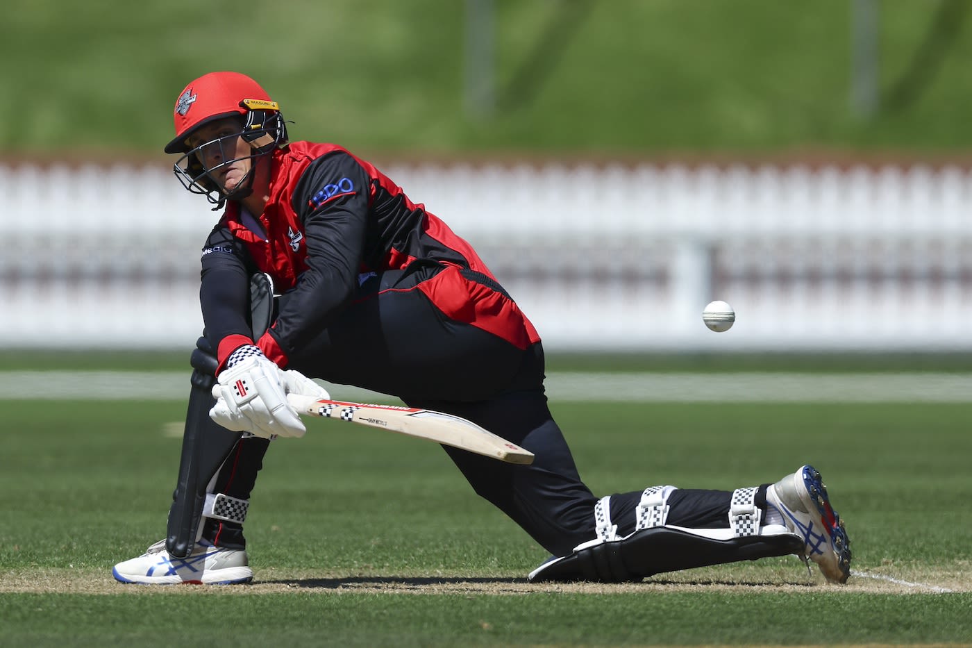 Rhys Mariu sweeps the ball