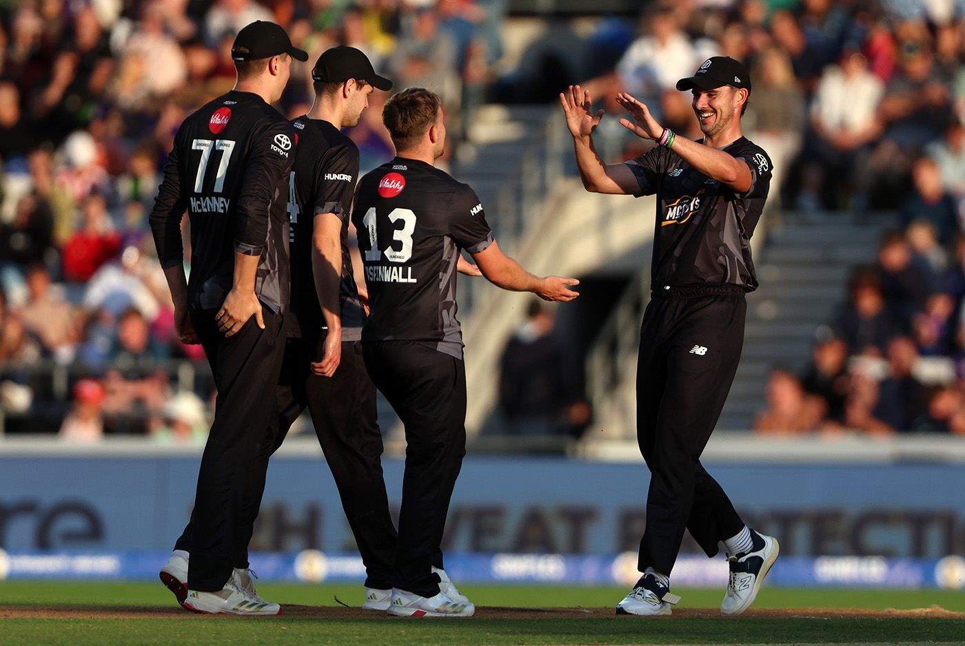 Tom Aspinwall celebrates with team-mate Josh Tongue after taking the wicket of Michael Pepper