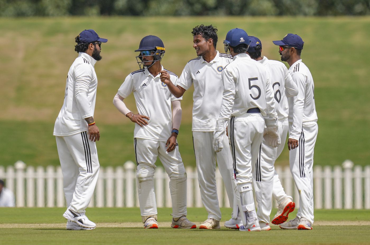Manishi celebrates a wicket with teammates