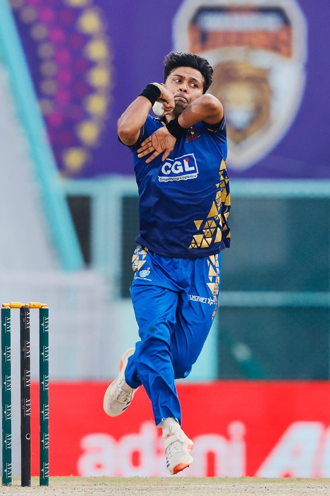 Zeeshan Ansari runs in to bowl
