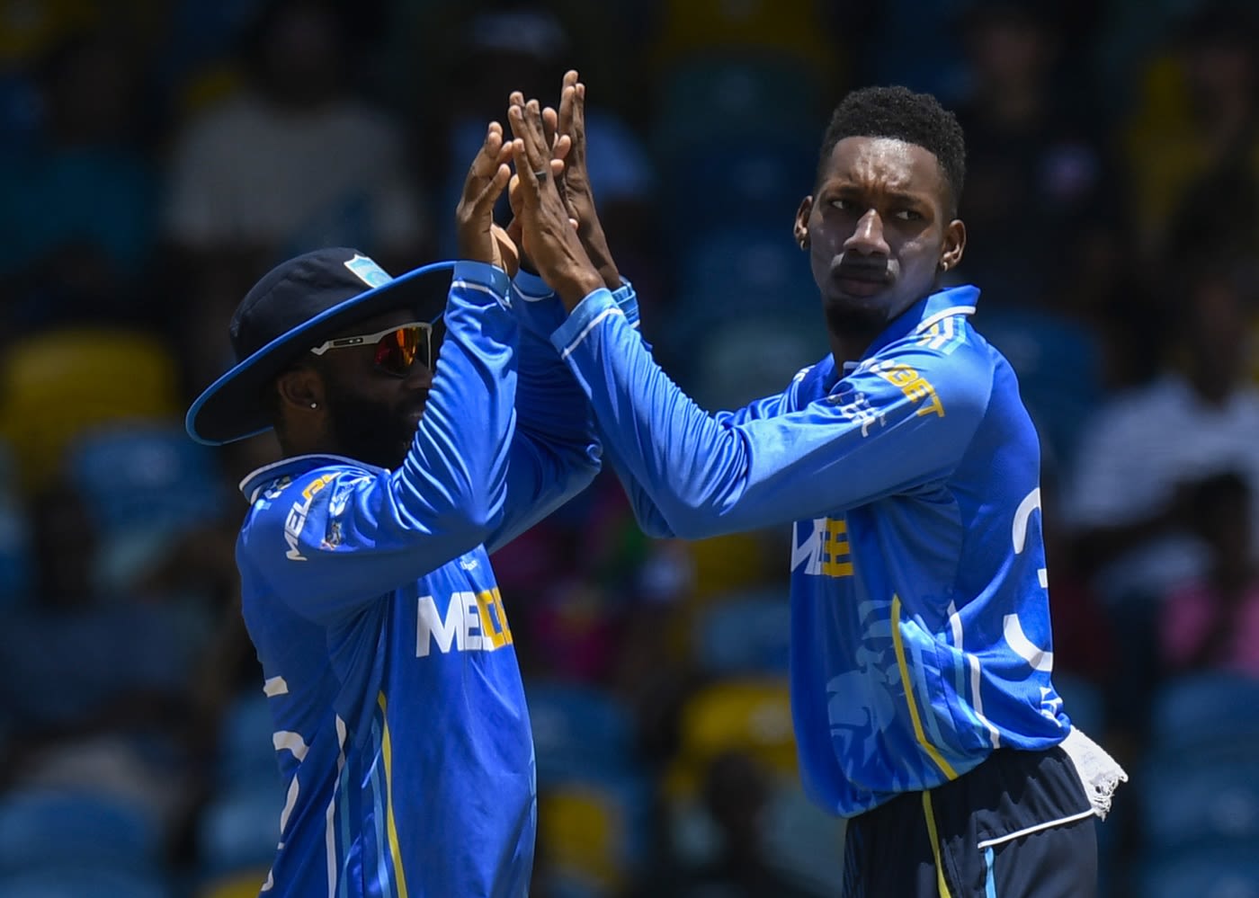 Khary Pierre celebrates a wicket with Aaron Jones