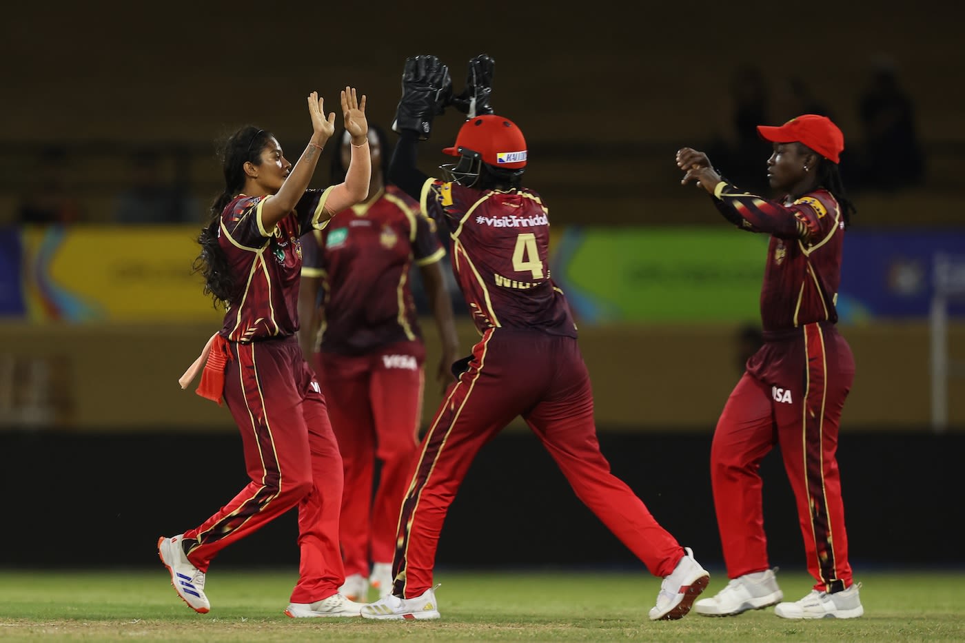 Salonee Dangore gets a high five after taking a wicket