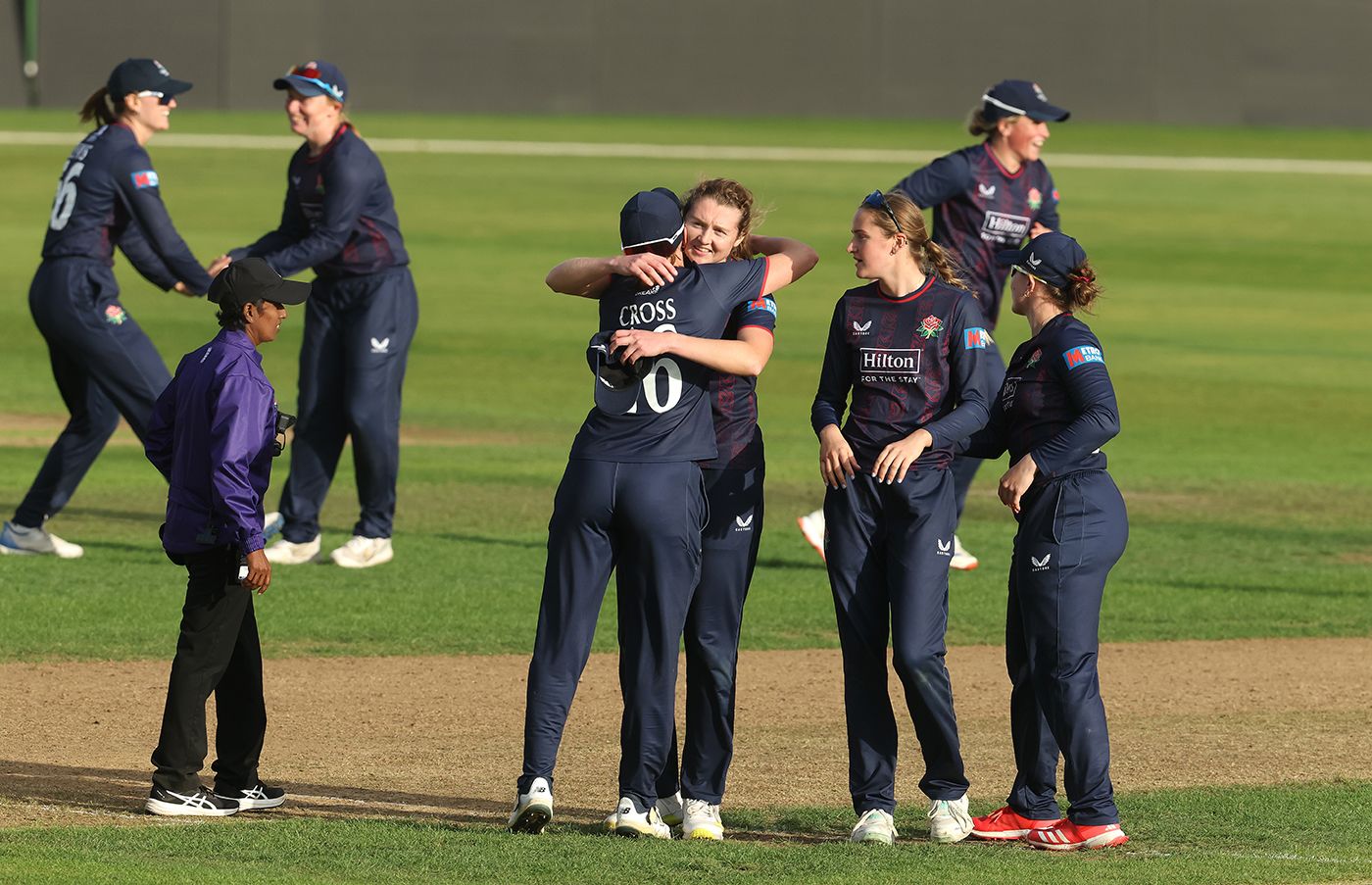 Grace Potts gets a hug from Kate Cross after helping seal victory