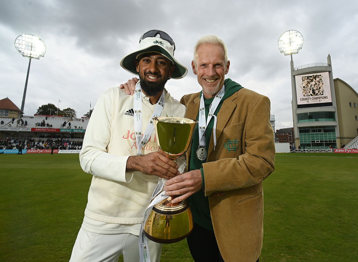 Haseeb Hameed and Peter Moores pose with the County Championship trophy