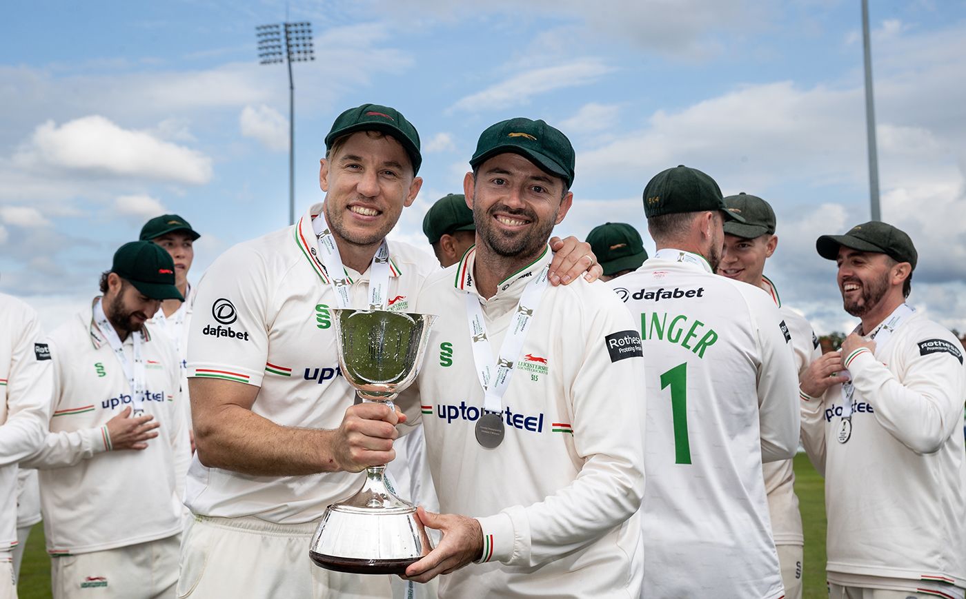 Logan van Beek and Leicestershire captain Ian Holland pose with the trophy