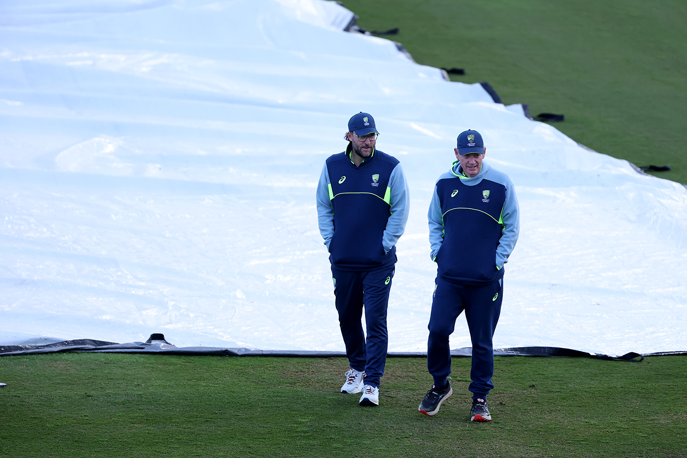 Daniel Vettori and Andrew McDonald walk past the covers