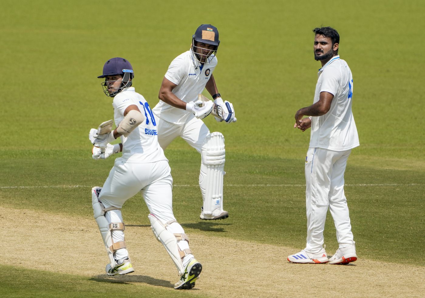 Bhupen Lalwani and Shashwat Dangwal run while Akash Deep watches on