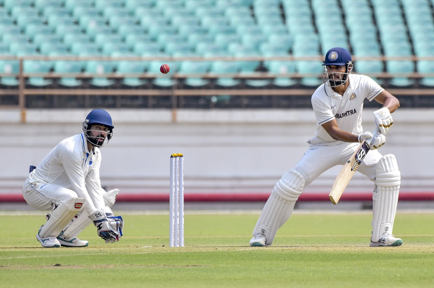 Chirag Jani hits through the off side as Himanshu Mantri looks on