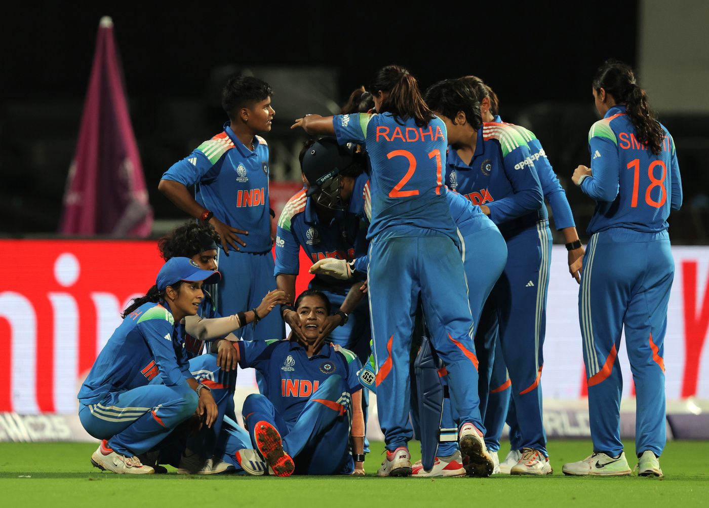 Amanjot Kaur is engulfed by her team-mates after taking a vital catch