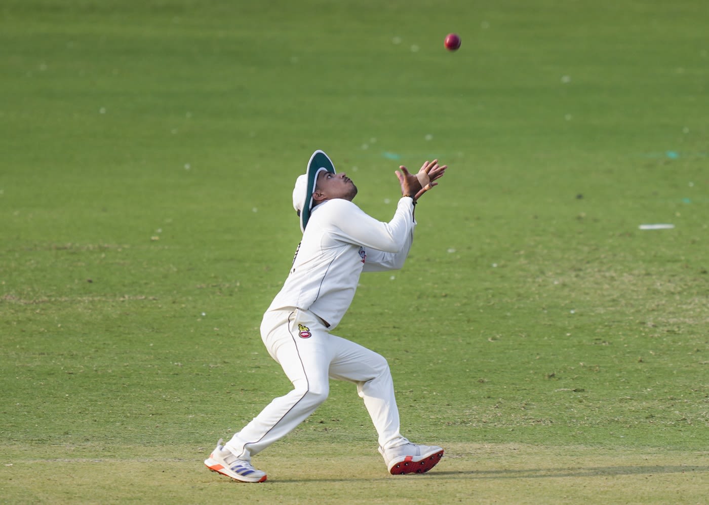 Delhi's Ayush Doseja settles under a catch