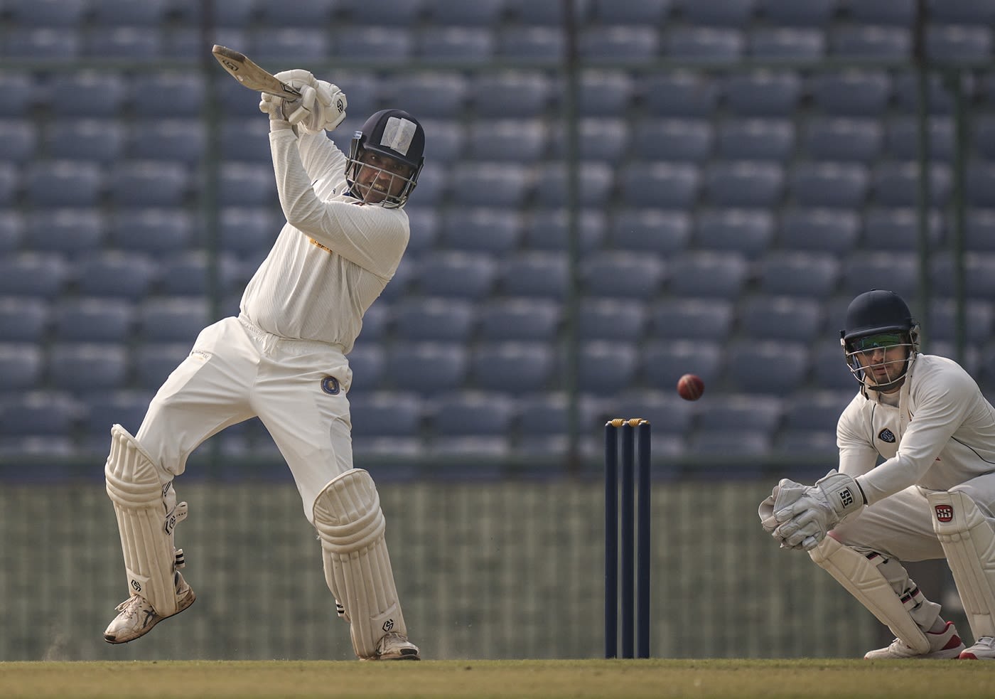 Sagar Udeshi punches the ball away