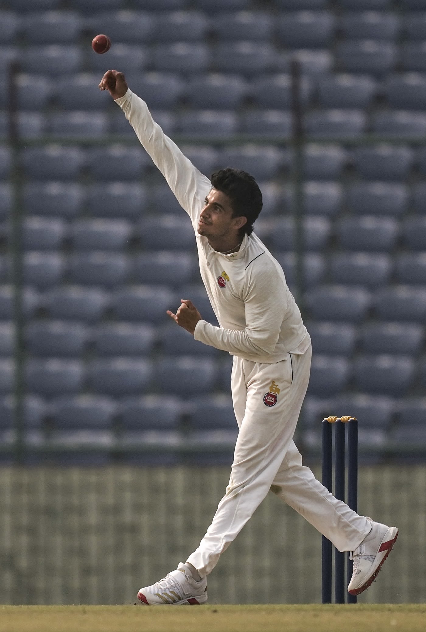 Hrithik Shokeen tosses the ball up