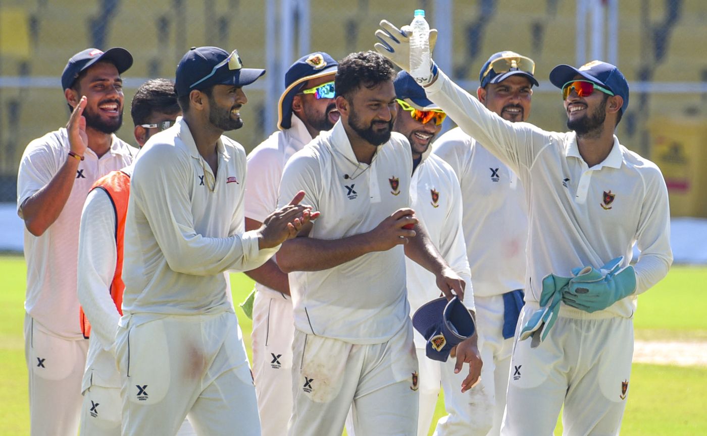 Adarsh Singh is cheered by his team-mates after taking a six-for