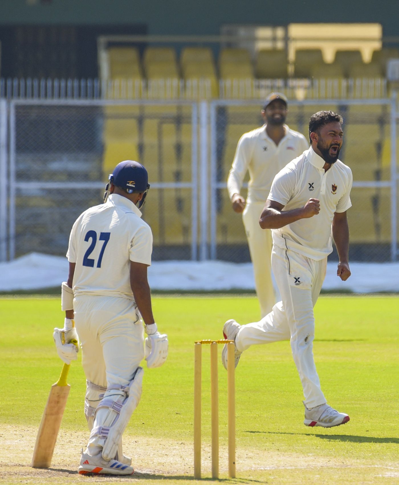 Adarsh Singh celebrates after taking a wicket