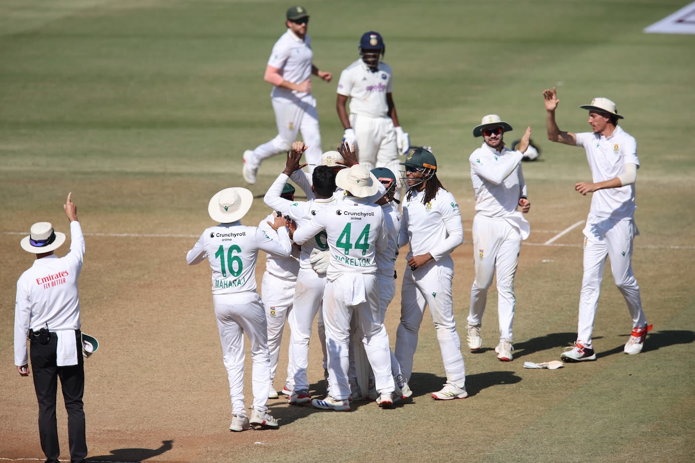 The South African team gets together to celebrate Senuran Muthusamy's first wicket