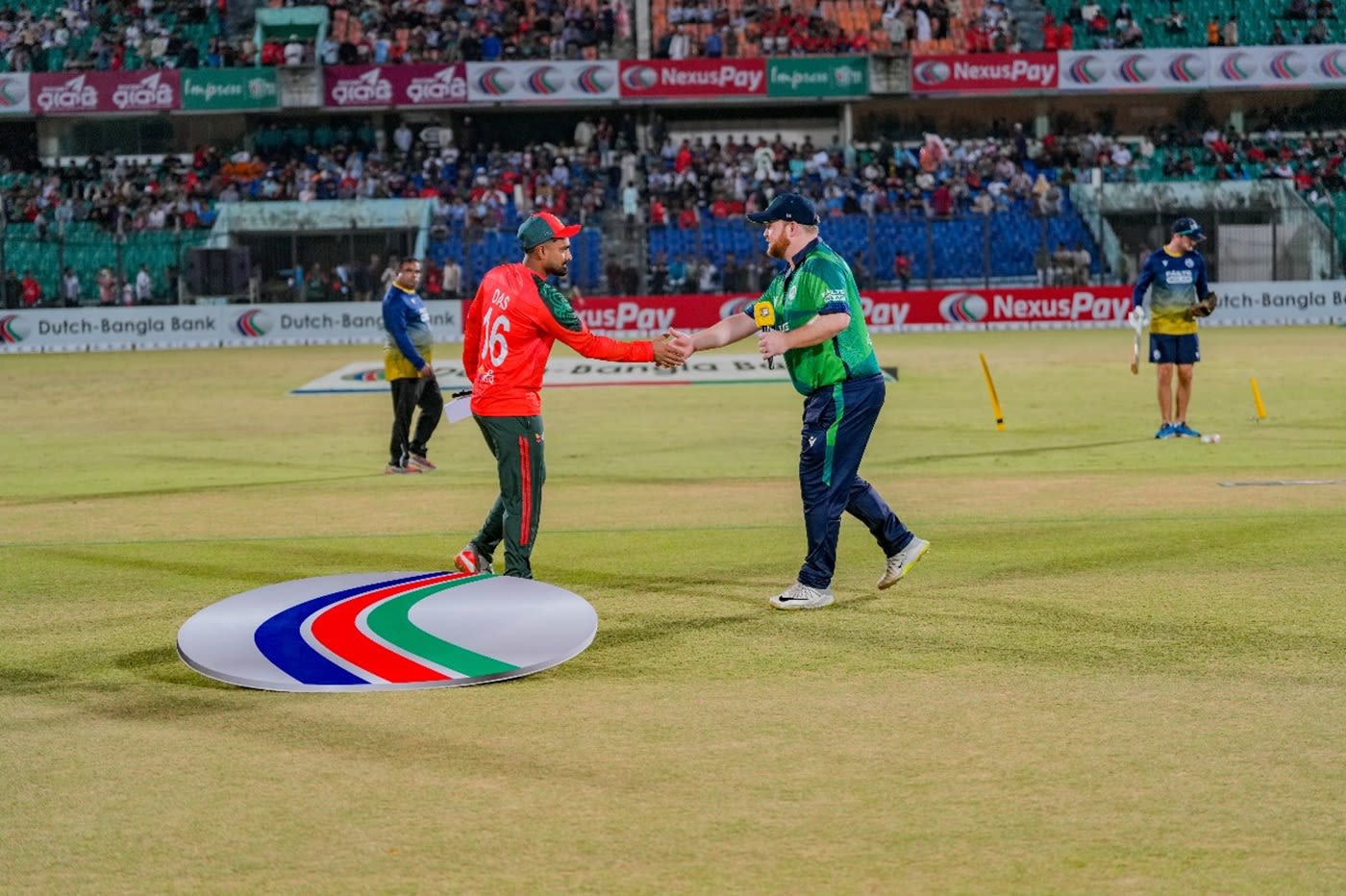Litton Das shakes hands with Paul Stirling at the toss