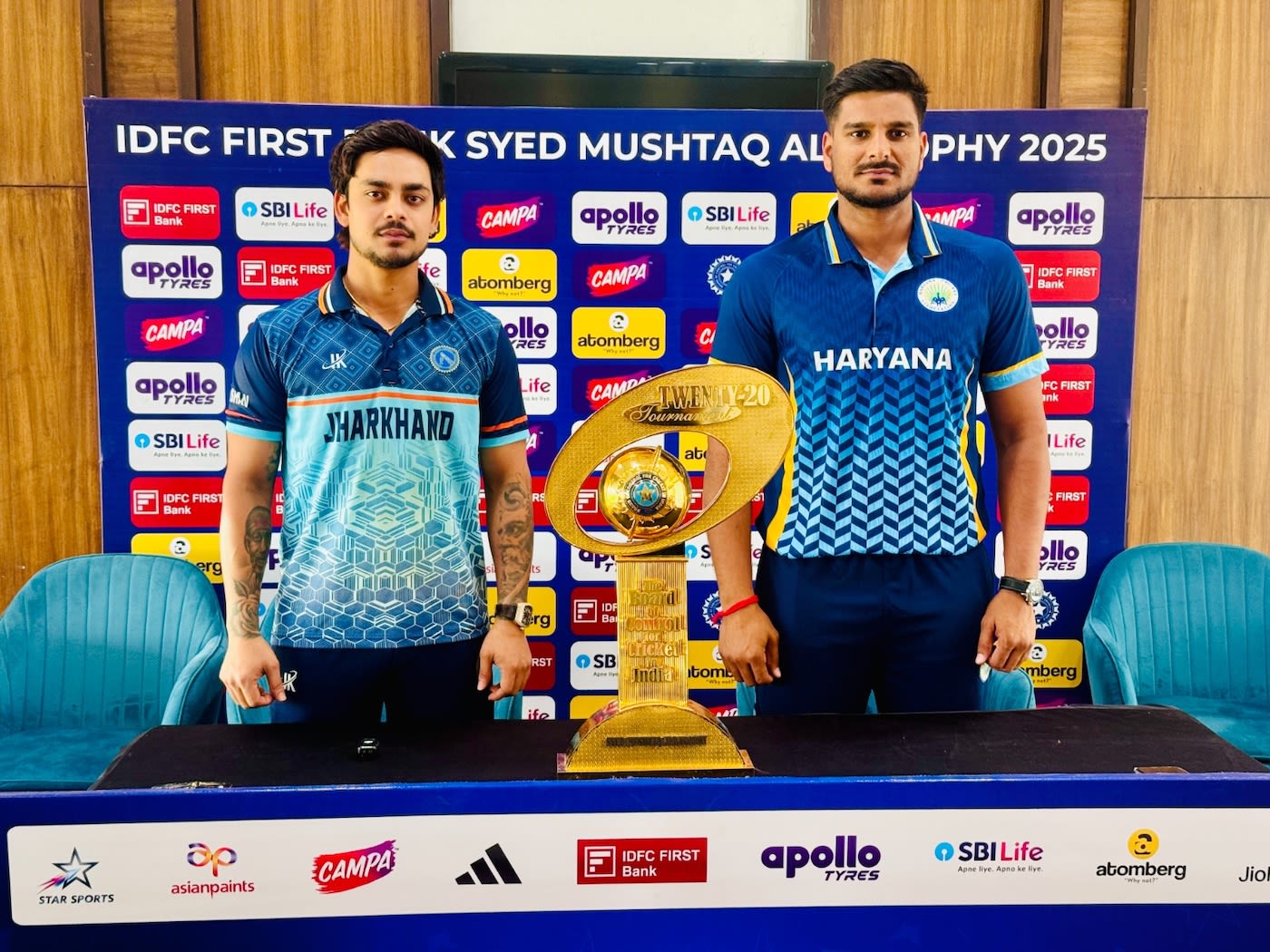 Ishan Kishan and Ankit Kumar, the two captains, pose with the trophy