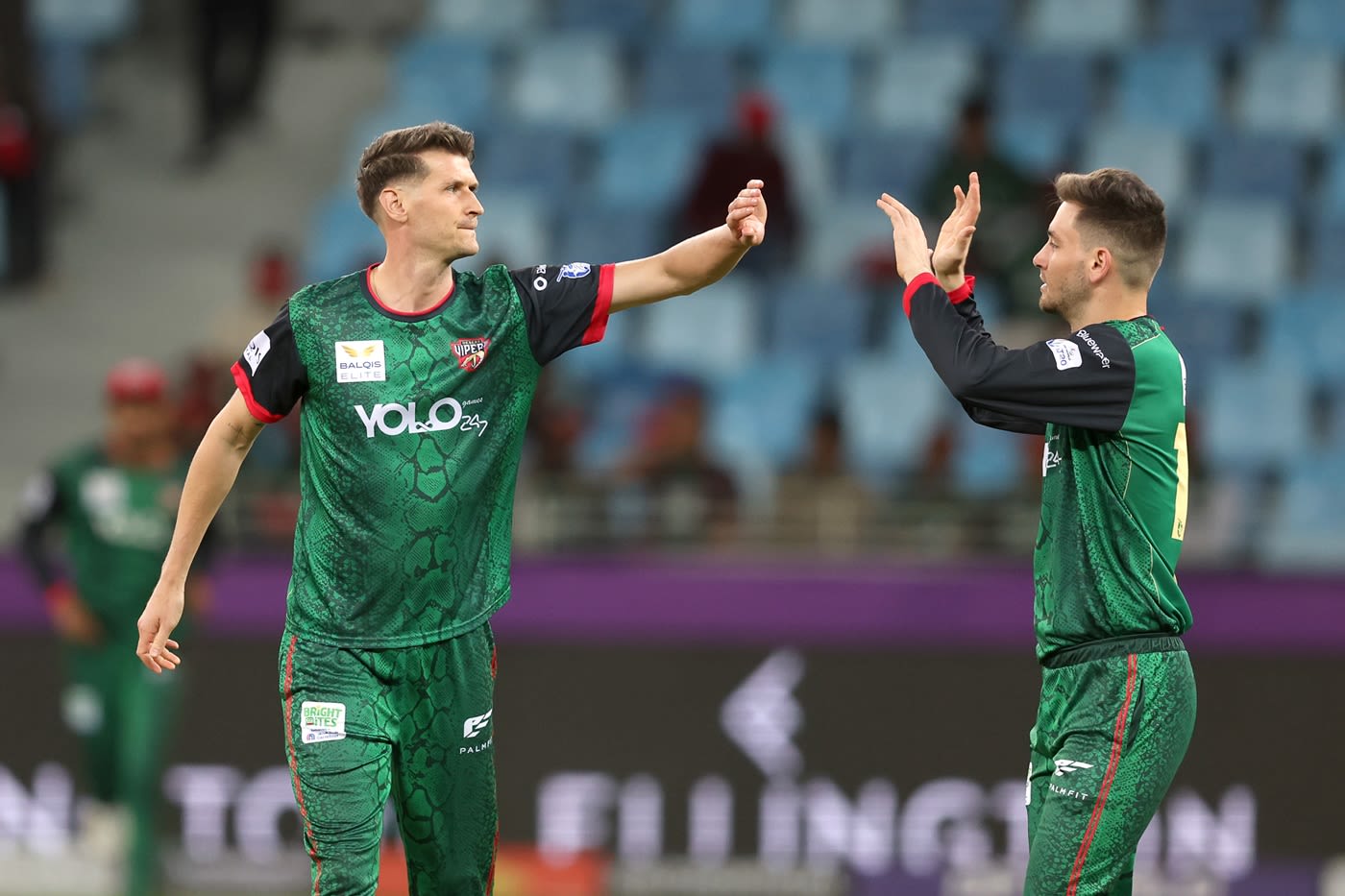 David Payne celebrates a wicket with Noor Ahmad
