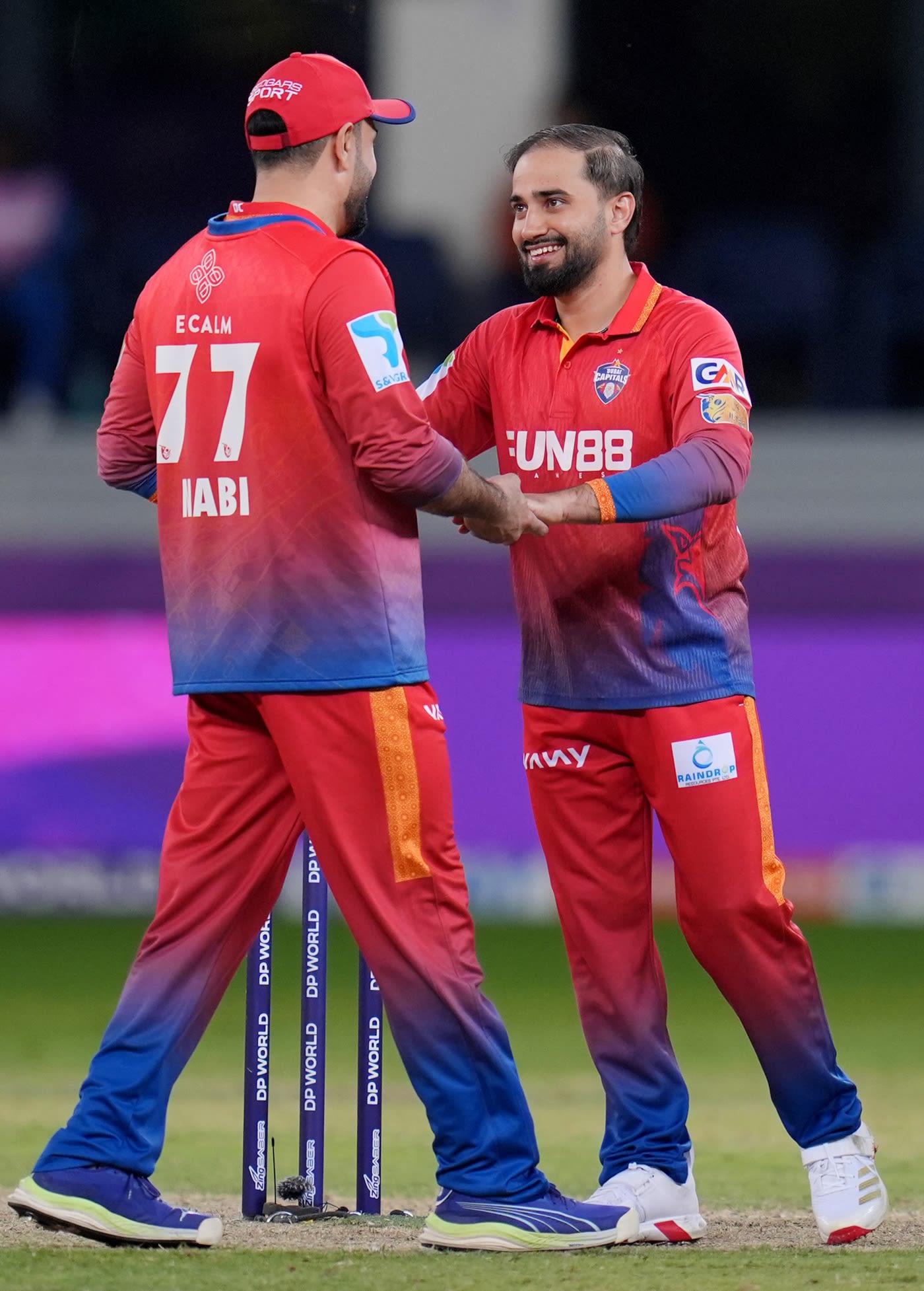 Waqar Salamkheil celebrates a wicket with Mohammad Nabi