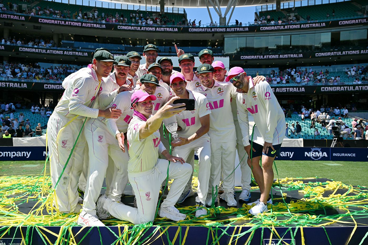 Australia pose with the Ashes trophy after sealing a 4-1 series win