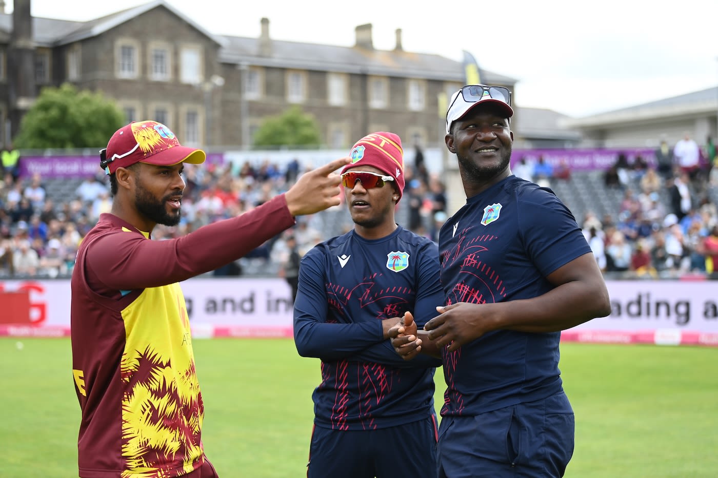 Shai Hope talks to Akeal Hosein and Daren Sammy