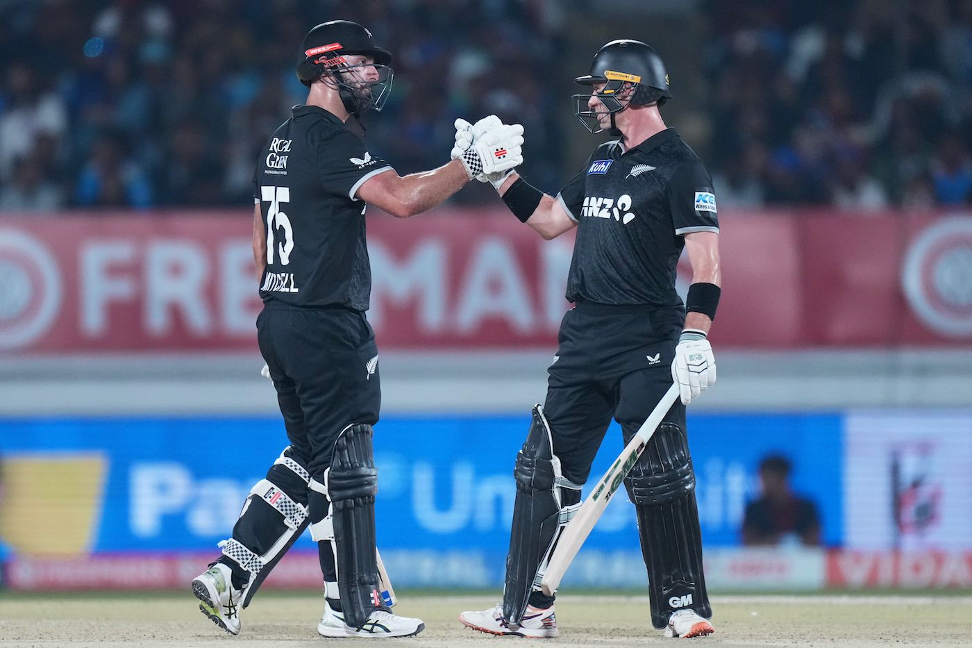 Daryl Mitchell and Will Young shake hands during their 162-run stand