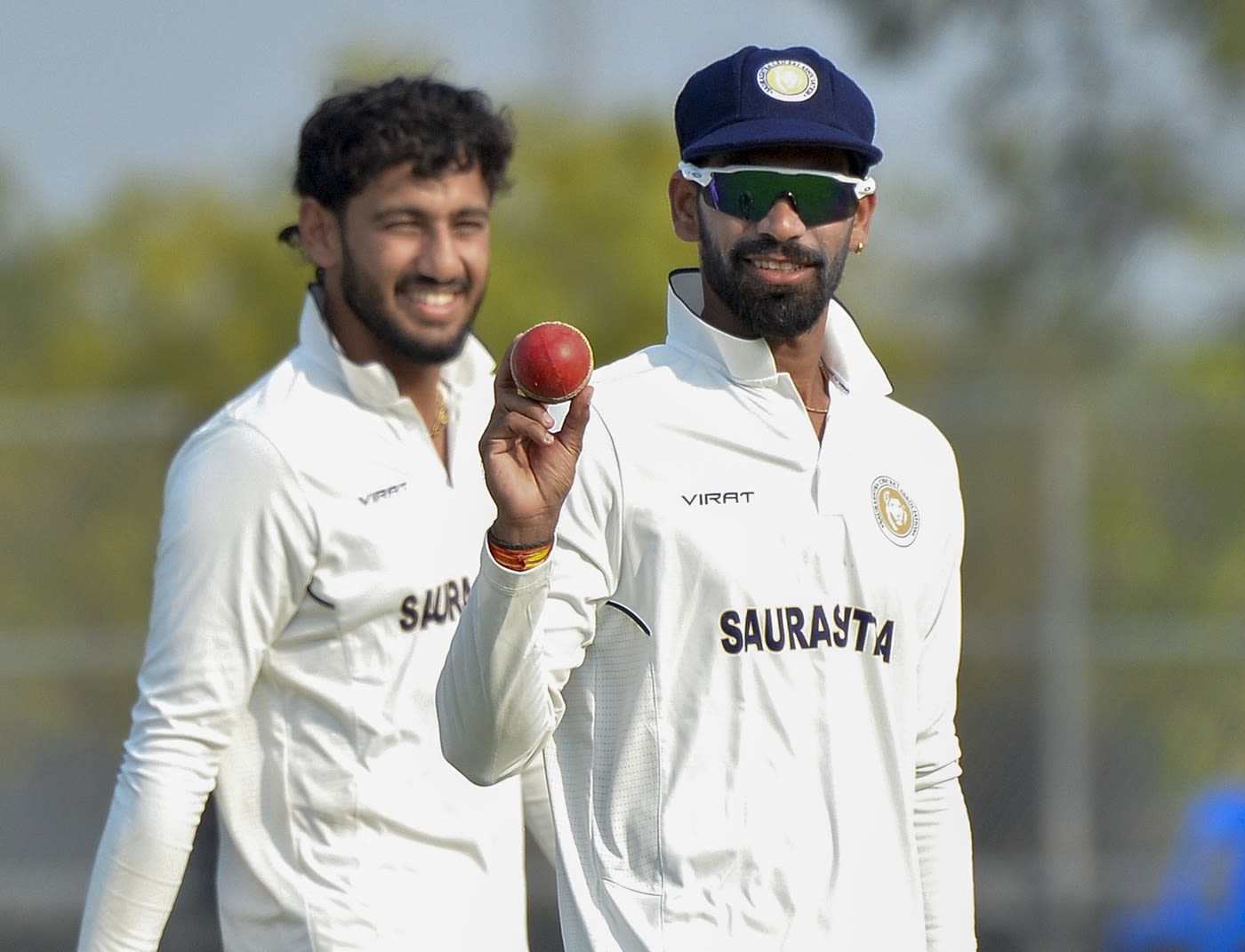 Parth Bhut holds the ball aloft after taking a five-for