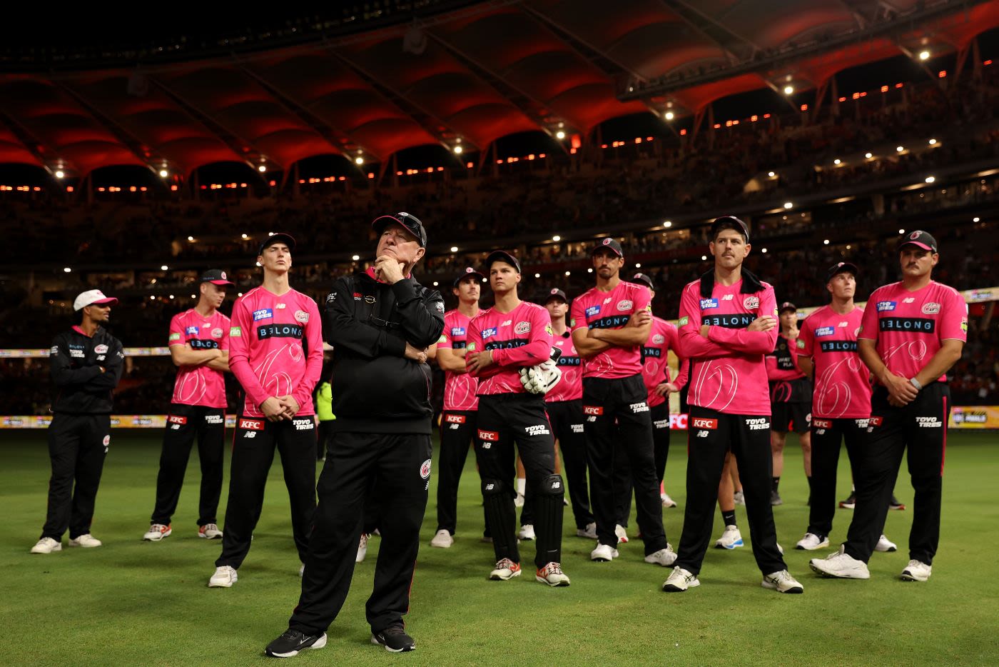 Coach Greg Shipperd and Sydney Sixers players look on at the trophy presentation