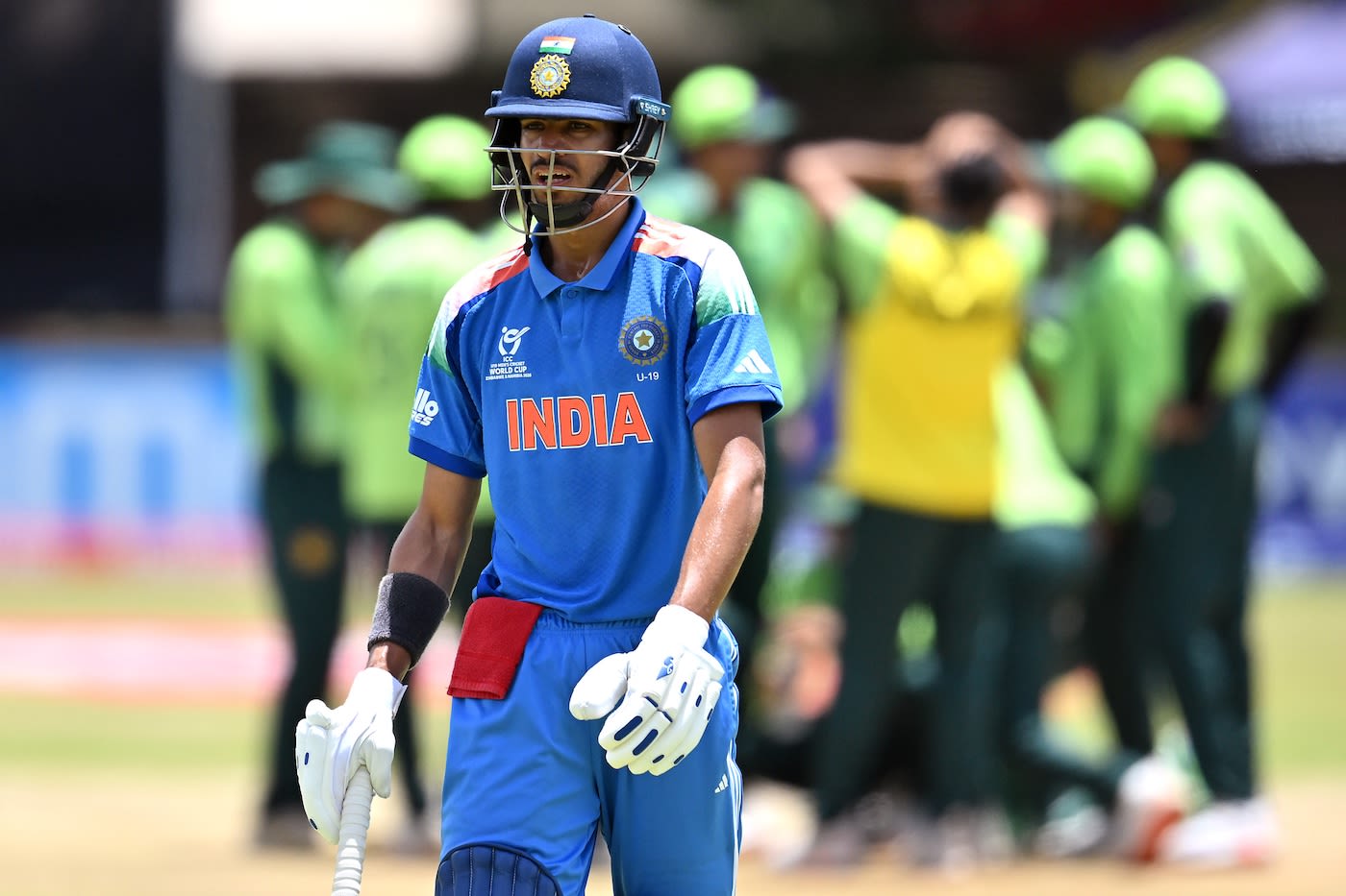 Vihaan Malhotra walks back after being dismissed by Ahmed Hussain